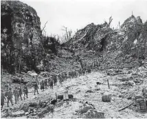  ??  ?? Defensive structures: Marines head inland towards one of the coral ridges, where Japanese soldiers dug caves and tunnels.