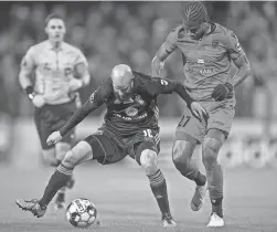  ?? BRYAN WOOLSTON/SPECIAL TO THE COURIER JOURNAL ?? Louisville City FC midfielder Brian Ownby plays against Phoenix Rising FC midfielder Kevon Lambert, right, in the USL Cup final played at Lynn Stadium in Louisville, Ky., in 2018.