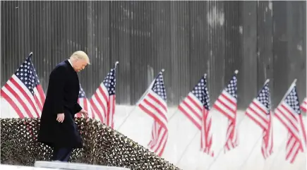  ?? DELCIA LOPEZ AP ?? President Donald Trump walks down the steps before a speech near a section of the U.S.-Mexico border wall on Tuesday in Alamo, Texas.