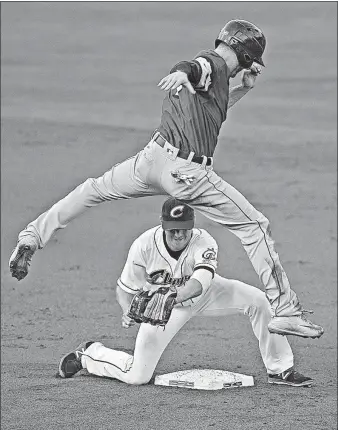  ?? [BARBARA J. PERENIC/DISPATCH] ?? Brendan Ryan of the Mud Hens leaps over the Clippers’ Josh Wilson after being forced out at second base.