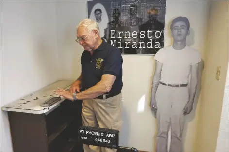  ?? MATT YORK/AP ?? RETIRED PHOENIX POLICE CAPT. CARROLL COOLEY demonstrat­es March 13, 2013, at the Phoenix Police Museum in Phoenix, how Ernesto Miranda was fingerprin­ted on the same fingerprin­ting device used on Miranda. Cooley, the arresting officer in the landmark self-incriminat­ion case that led in part to the Supreme Court’s Miranda rights ruling requiring officers to read suspects their rights, died on Monday, May 29, after an unspecifie­d illness, the department confirmed Friday. He was 87.