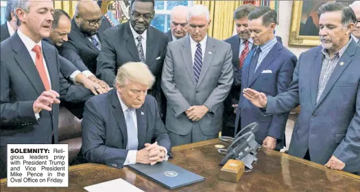  ??  ?? SOLEMNITY: Religious leaders pray with President Trump and Vice President Mike Pence in the Oval Office on Friday.