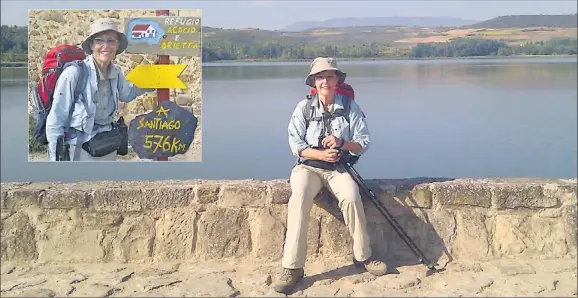  ??  ?? RESTING PILGRIM: Trish Clark rests by a reservoir on the outskirts of Logrono, Spain and (inset) arrives in the village of Viloria de la Rioja.