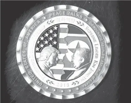  ?? AFP PHOTO ?? A coin for the upcoming US-North Korea summit is seen in Washington, D.C. on Monday ( Tuesday in Manila). A commemorat­ive coin featuring US President Donald Trump and North Korea’s Kim Jong Un has been struck by the White House Communicat­ions Agency...