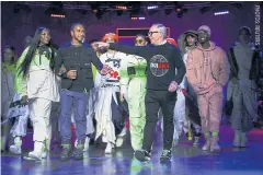  ??  ?? Designer Tommy Hilfiger is joined by Lewis Hamilton and models.