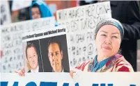  ?? JASON REDMOND AFP/GETTY IMAGES FILE PHOTO ?? Protesters in Vancouver last year raise the plight of Michael Spavor and Michael Kovrig, who could now face life in prison.