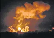  ?? AFP ?? Smoke and fireball rises following an air strike in Khan Yunis in the southern Gaza Strip, early on Sunday.