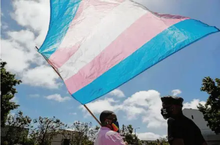  ?? Scott Strazzante/The Chronicle 2020 ?? San Francisco Pride board member Carolyn Wysinger waves a transgende­r flag during the Marsha P. Johnson Solidarity Rally.