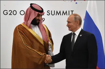  ?? YURI KADOBNOV / ASSOCIATED PRESS FILE (2019) ?? Russian President Vladimir Putin, right, shakes hands with Saudi Arabia’s Crown Prince Mohammed bin Salman on June 29, 2019, in Osaka, Japan.