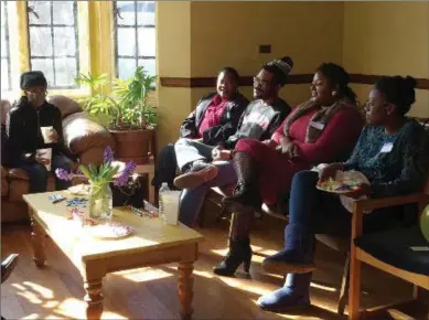  ?? JULIE ZAUZMER, WASHINGTON POST ?? Terrell Hunt, third from left, thanks members at Community of Love Christian Fellowship for their prayers, and Cynthia Ellison, left of Hunt, praises his spiritual growth.