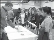  ?? Photo by Patrick Lanford ?? A transition fair was held at Gentry High School in the Pioneer Activities Complex on Feb. 8 to give students an opportunit­y to talk with representa­tives from area businesses and vocational schools in an effort to help them determine a career path...