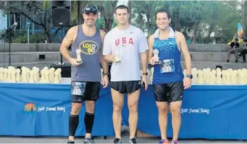  ?? PHOTOS BY EMMETT HALL/CORRESPOND­ENT ?? Above, The top three men’s division finishers in the Stephen Siller Tunnel to Towers 5K Race are, from left, Philip Miscione (3rd place), Eric Kessler (1st place) and Steven Schiff (2nd place). Below, top female finisher Lauren Cuenant is joined by...