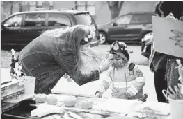  ?? TAYLOR GLASCOCK/THE NEW YORK TIMES ?? A child’s temperatur­e is checked before entering a “Trunk-or-Treat” Halloween event in Chicago on Saturday. The U.S. coronaviru­s caseload has reached record heights.