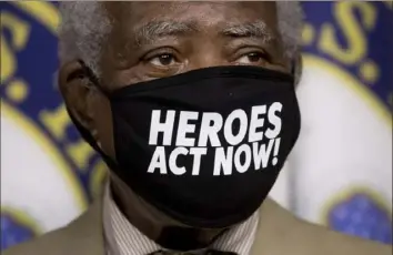  ?? Andrew Harnik/Associated Press ?? Rep. Danny Davis, D-Ill., wears a mask that reads “Heroes Act Now” as he appears at a news conference Friday for the extension of federal unemployme­nt benefits on Capitol Hill in Washington.