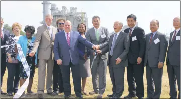  ?? STAFF PHOTO BY MATTHEW KUBISIAK ?? Gov. Larry Hogan, CPV President and CEO Gary Lambert and Ambassador of Japan Kenichiro Sasae cut the ribbon outside of the CPV St. Charles Energy Center in Waldorf during the natural gas power plant’s dedication ceremony on June 13. Business leaders,...
