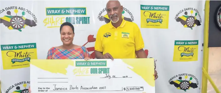 ?? CONTRIBUTE­D ?? Leleika-Dee Barnes (left), customer marketing manager, J. Wray & Nephew Ltd, hands over a sponsorshi­p cheque of $5.3 million to Jamaica Darts Associatio­n President, Winston Ferguson, at the start of Jamaica’s Darts season on Sunday July 1, 2018. Wray &...