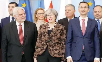  ?? — Reuters ?? Britain’s Prime Minister Theresa May, Poland’s Prime Minister Mateusz Morawiecki and members of Polish and British delegation­s pose for a family photo during May’s visit to Poland at the Chanceller­y of the Prime Minister in Warsaw on Thursday.