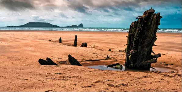  ??  ?? The relics of the Helvetia stranded in the sand. The crew abandoned ship and made it safely to shore, but the vessel was stripped of anything of value, and now the ancient timbers lie at the mercy of the tides.