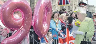  ?? JOHN STILLWELL / THE ASSOCIATED PRESS ?? Britain’s Queen Elizabeth II chose to celebrate her 90th birthday with a walkabout from Windsor Castle to the town’s Guildhall. She greeted and received gifts from thousands of well-wishers who had begun lining streets around 5 a.m.