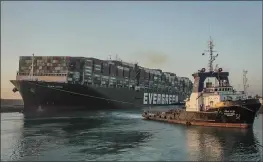  ?? SUEZ CANAL AUTHORITY VIA AP ?? The Ever Given, a Panama-flagged cargo ship, is pulled by one of the Suez Canal tugboats, in the Suez Canal, Egypt, Monday.