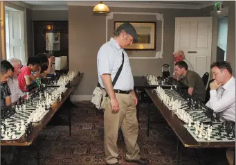  ??  ?? Internatio­nal chess expert Manuel Gardenes takes on fifteen chess players all at once in a simultaneo­us chess exhibition in the Loch gCarman Arms, Gorey.