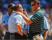  ?? OTTO GREULE JR. / GETTY IMAGES ?? Home plate umpire Dale Scott is examined by a trainer after being hit by a foul ball in 2013 in Seattle. Scott missed nearly the entire 2017 season with head injuries. He has since retired.