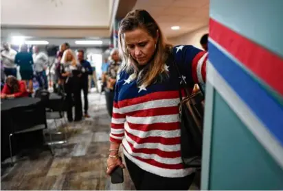  ?? CAROLYN KASTER/AP ?? A woman bows her head during a prayer at a watch party at the Center for Christian Virtue in Columbus, Ohio, on Nov. 7.