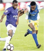  ?? FILE ?? Omar Thompson of Kingston College and Nickjay White (right) of St Elizabeth Technical High School battle during the ISSA-FLOW Super Cup final at Sabina Park last year.