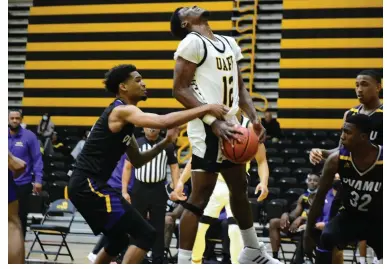  ?? (Pine Bluff Commercial/I.C. Murrell) ?? Terrance Banyard of the University of Arkansas at Pine Bluff goes up for a shot as a Prairie View A&M player reaches in for the strip during a Jan. 25 game at H.O. Clemmons Arena. UAPB has not won a game since Jan. 9, when it defeated Alabama State.