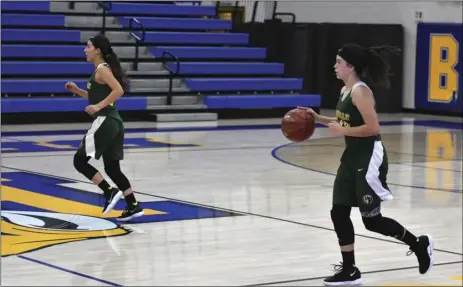  ?? PHOTO AARON BODUS ?? Holtville’s Orian Anderson (right) advances the ball late during the Vikings’ 55-50 overtime win over Brawley on Friday night. Anderson would hit a buzzer-beating three to tie the game at 46-46 at the end of the fourth.