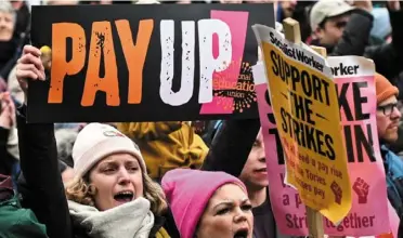  ?? — AFP ?? Inflation pressure: Teachers holding placards in Manchester on Wednesday during a demonstrat­ion. Strikes by public service workers have added to the sense of gloom in an economy still struggling to adjust to brexit and the coronaviru­s pandemic.