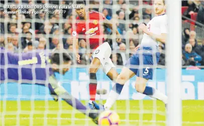  ?? Picture: AFP ?? MARCUS RASHFORD (centre) slots in Manchester United’s goal.