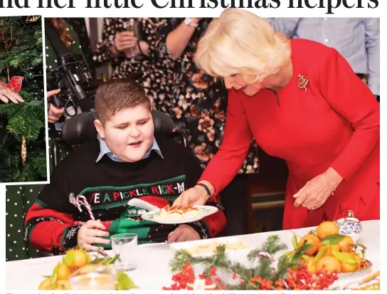  ??  ?? Silver service: Camilla hands out plates of sausage and mash to seriously ill youngsters at Clarence House yesterday