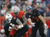  ?? BRYNN ANDERSON — THE ASSOCIATED PRESS ?? South quarterbac­k Kurt Benkert of Virginia is sacked by North defensive end Jalyn Holmes of Ohio State during the first half of the Senior Bowl on Jan. 27 in Mobile, Ala.