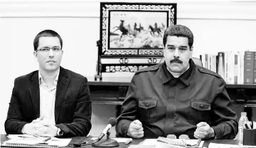  ?? — Reuters photo ?? File photo shows Maduro (right) talking next to Venezuela’s vice-president Jorge Arreaza during a Council of Ministers meeting at Miraflores Palace in Caracas.