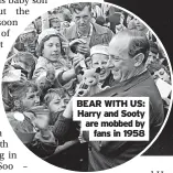  ?? ?? BEAR WITH US: Harry and Sooty are mobbed by fans in 1958