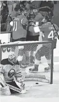  ?? JIM RASSOL/AP ?? Panthers center Sam Bennett, top right, celebrates with teammates after scoring against Sabres goaltender Dustin Tokarski Friday in Sunrise, Fla.