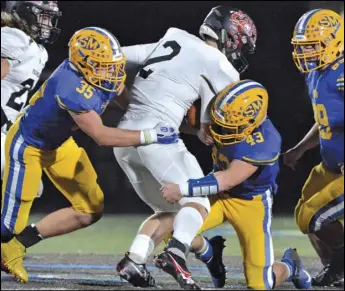  ?? Staff photo/Jake Dowling ?? St. Marys’ Tanner Howell (35) and Brandon Paul (43) tackle Franklin quarterbac­k Tressel Gibson (2)