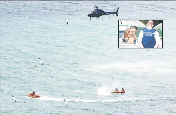  ?? (AP) ?? Police in inflatable rubber boats shoot at a shark off Muriwai Beach near Auckland, New Zealand, Feb 27, as they attempt to retrieve a body following a fatal shark attack. Police said a man found dead in the water after being ‘bitten by a large shark’....