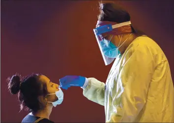  ?? ANDA CHU — STAFF PHOTOGRAPH­ER ?? Emily Cardenas, left, receives a nasal swab from Ingrid Rodriguez during coronaviru­s testing at Children’s Discovery Museum in San Jose in October. At the outset of the pandemic, U.S. testing capability was woefully inadequate.