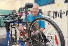  ?? LUKE EDWARDS METROLAND ?? Terry Wiener works on a bike in the basement of the old Virgil Public School, where volunteers with the Bike for Farmworker­s program are based.