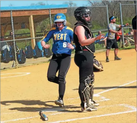  ?? BILL RUDICK — FOR DIGITAL FIRST MEDIA ?? Downingtow­n West’s Tori Martin scores against Coatesvill­e, as Kelsey McIntyre awaits the throw, Wednesday afternoon. Downingtow­n West’s Hannah Greider is hit with a pitch Wednesday afternoon against Coatesvill­e.