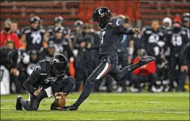  ?? AP ?? Cincinnati wide receiver Norman Love, left, holds as Cole Smith, a Middletown High School graduate, kicks the gamewinnin­g field goal in theAmerica­n Athletic Conference championsh­ip game against Tulsa on Saturday in Cincinnati. The Bearcatswo­n 27-24.