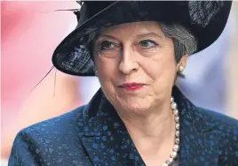  ?? Pictures: PA/Getty ?? Top: Governor of Edinburgh Castle Major General Mike RiddellWeb­ster lays a wreath by a drum altar during the parade and service in Crieff. Above: Prime Minister Theresa May at the Ypres ceremony.