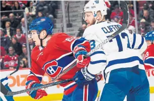  ?? ICON SPORTSWIRE GETTY IMAGES ?? Artturi Lehkonen of the Montreal Canadiens and Kyle Clifford of the Toronto Maple Leafs battle for position during the first period. Kyle Dubas said he acquired Clifford for his competitiv­e streak.