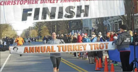  ?? PHOTOS BY JOSEPH PHELAN JPHELAN@DIGITALFIR­STMEDIA.COM ?? Above, Dana Bush, principal at Dorothy Nolan Elementary School, was top female finisher Thursday. Below, Joe Verro won the Christophe­r Dailey Annual Turkey Trot Thursday morning.