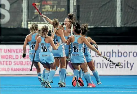  ?? GETTY IMAGES ?? Argentina players surround Noel Barrionuev­o after she converted a penalty stroke against the Black Sticks.