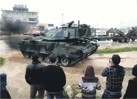  ?? Reuters ?? A Turkish military convoy at an army base in the Turkish border town of Reyhanli near the Syrian border in Hatay province