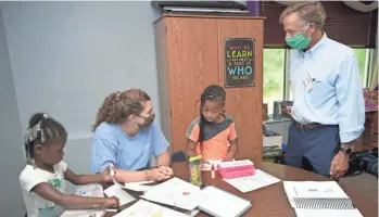  ?? SHELLEY MAYS/ THE TENNESSEAN ?? Former Gov. Bill Haslam tours a Tennessee Tutoring Corps program at the Boys & Girls Club of Middle Tennessee in Franklin on July 7. The statewide program provides summer learning opportunit­ies.