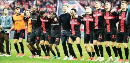  ?? ?? Bayer Leverkusen players celebratin­g ending Bayern Munich’s 11 years reign as German Bundesliga champions on Sunday night